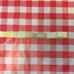 2/$15. Ivory elastic belt with gold and Faux Pearl buckle